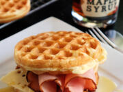 A drizzle of real maple syrup gives a ham and cheese waffle sandwich a sweet finish.