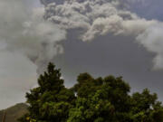 Plumes of ash rise Friday from the La Soufriere volcano as it erupts on the eastern Caribbean island of St.