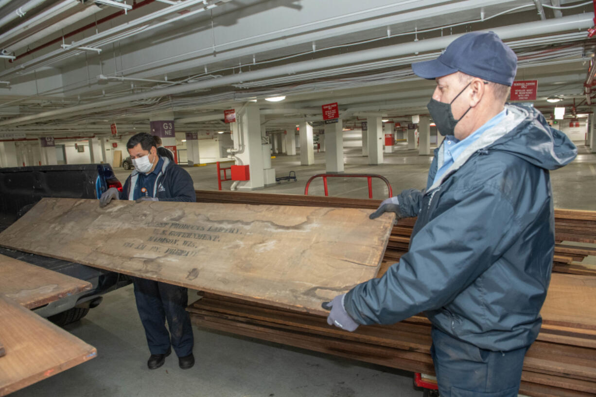 Architects of the Capitol staff hold rare century-old mahogany obtained from a U.S. Forest Service lab storage locker in Wisconsin. This historic mahogany lumber, received from USDA Forest Service's Forest Products Laboratory, will be used to replace U.S. Capitol doors and other wood details damaged during the January 2021 breach.