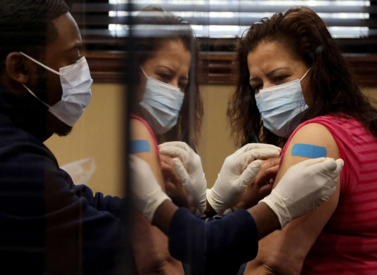 Ferrara Candy employee Leonor Soberanis after receiving her Moderna COVID-19 vaccine on April 15, 2021. Some companies are organizing vaccination clinics for their employees on site.