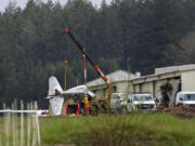 Crews work Thursday to remove a small plane that crashed into the far west hangar at Grove Field. A family member said Mark Lewallen of Vancouver died in the crash, while a second pilot providing instruction was seriously injured in the crash, which occurred around 3:15 p.m. Wednesday. The National Transportation Safety Board and Federal Aviation Administration were investigating the incident Thursday.