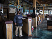 Beaches server April Martinell brings a plate of bread to customers. Restaurants returned to limited indoor dining in February.