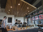 Jeremy Young of Vancouver, left, places an order with cashier Amanda Eckert at the newly opened Kafiex Gastro Caf&#039;e location at The Waterfront Vancouver.