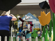 Melissa Brewer of 4Ever Photography snaps a shot of the Dees family - which includes 5-year-old Miles, 11-month-old Zane and mom Renee - with the Easter Bunny on Saturday at the Vancouver Mall.