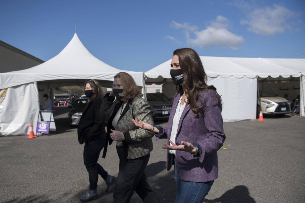 Clark County Councilor Temple Lentz, from left, joins Mayor Anne McEnerny-Ogle and Rep. Jaime Herrera Beutler as they tour the Tower Mall vaccination site on Monday in Vancouver. The site also offers rapid COVID-19 testing.