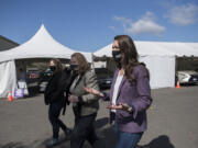 Clark County Councilor Temple Lentz, from left, joins Mayor Anne McEnerny-Ogle and Rep. Jaime Herrera Beutler as they tour the Tower Mall vaccination site on Monday in Vancouver. The site also offers rapid COVID-19 testing.