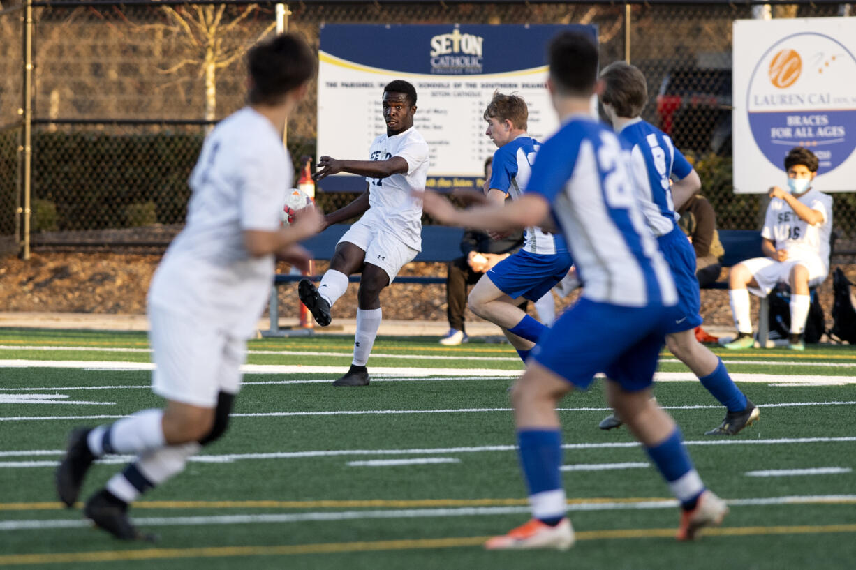 Seton Catholic’s David Moore threads the needle through the La Center defense with a long pass to a teammate on Tuesday, April 13, 2021, at Seton Catholic Preparatory School. The Cougars won 3-1 in the 1A Trico League game.