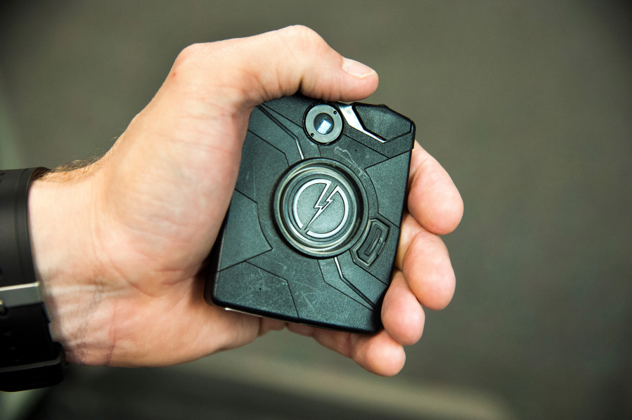 Officer Ryan Snider holds a body camera used by the Spokane Police Department in 2016.