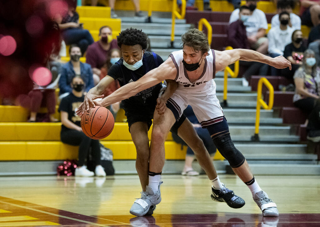 Heritage’s Vernon Onick, left, wrestles for the ball with Prairie in 4A/3A Greater St.