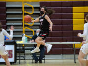 Union’s Abbey Kaip leaps to save the ball from going out of bounds in a 4A/3A Greater St. Helens League girls basketball game on Thursday, April 22, 2021, at Prairie High School. Union won 50-46.