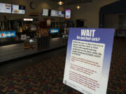 A sign in the entryway alerts customers to COVID-19 restrictions at Battle Ground Cinema. Clark County movie theaters are reopening, but owners are still waiting on a federal grant program intended to help them stay afloat.