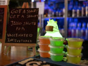 A display alerts customers to Vault 31 Bar's vaccination incentive offer. Vault 31 is giving away free jello shots to guests who can prove they were received a COVID-19 vaccination.