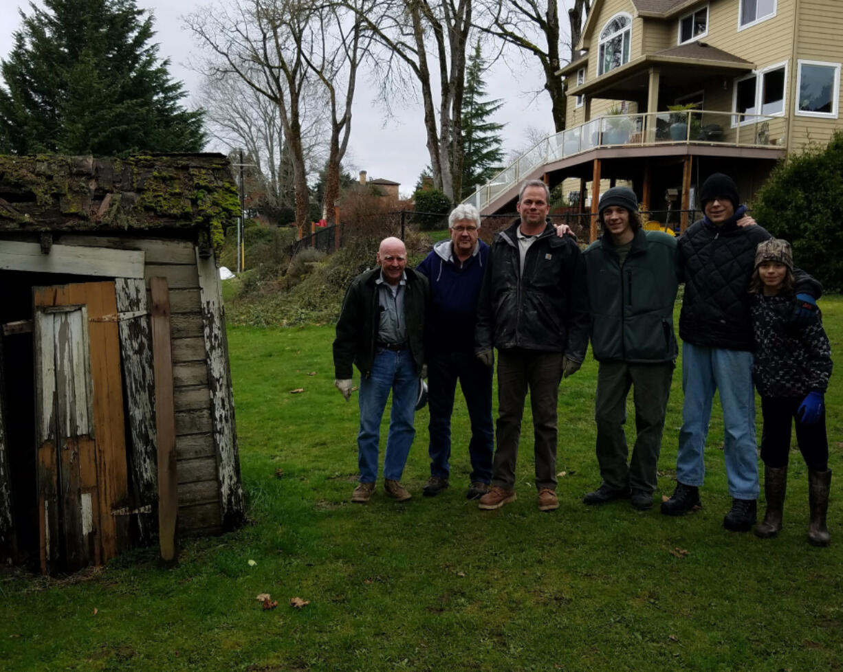 OLD EVERGREEN HIGHWAY: From left is Don Stuart (great grandfather), Paul Cline (grandfather), Jeremy Stuart (father), Tiger, and brothers Ryker and Rogen Stuart, both Star Rank Scouts with Troop 14, at the Jane Weber Evergreen Arboretum.