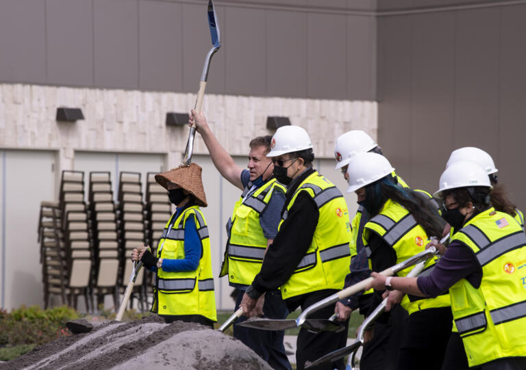 Cowlitz Tribe vice chairman Dick Barnett raises his shovel in the air after making some of the first digs on Friday, April 23, 2021, at the ilani on the Cowlitz Indian Reservation. The casino broke ground Friday on a 14-story luxury hotel.