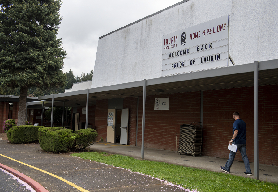 A sign welcomes back students and teachers at Laurin Middle School in Battle Ground on Monday morning, the first day in the district's five-day-a-week instructional plan.