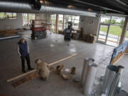 George Goodrich, left, and his daughter, Gwen, look over samples of booth material for the Cove Restaurant. The Cove announced plans to open as the first commercial business at Tidewater Cove on the Columbia River.