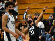 Union High School senior Cole Rebman, 21, celebrates a three point shot Tuesday, April 27, 2021, during the TitanÕs 79-71 win against Skyview High School at Skyview.