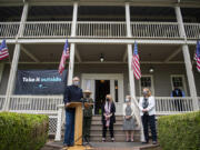 Gov. Jay Inslee talks to members of the media during a press conference about the "Take It Outside" program to prevent disease transmission. Also pictured are Tracy Fortmann, second from left, superintendent of Fort Vancouver National Historic Site, Stacey Graham, with scarf, interim president of The Historic Trust, Liz Luce of Friends of Fort Vancouver Historic Site and Vancouver Mayor Anne McEnerny-Ogle.