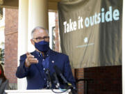 Washington Gov. Jay Inslee speaks to reporters outside of the governor's mansion on the Capitol campus Thursday, April 15, 2021, in Olympia, Wash. Inslee held the outdoor news conference to urge people to get vaccinated and to socialize and conduct business outside as much as possible to help slow further the spread of COVID-19.