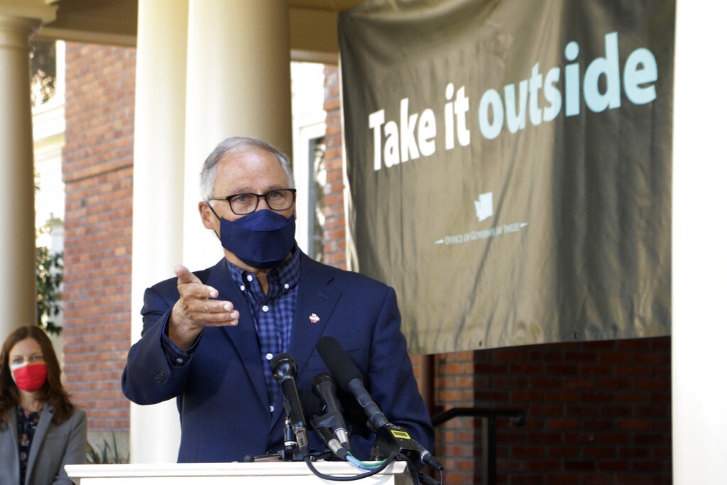 Washington Gov. Jay Inslee speaks to reporters outside of the governor's mansion on the Capitol campus Thursday, April 15, 2021, in Olympia, Wash. Inslee held the outdoor news conference to urge people to get vaccinated and to socialize and conduct business outside as much as possible to help slow further the spread of COVID-19.