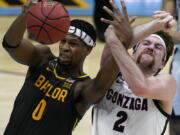 Baylor forward Flo Thamba (0) fights for a rebound with Gonzaga forward Drew Timme (2) during the first half of the championship game in the men&#039;s Final Four NCAA college basketball tournament, Monday, April 5, 2021, at Lucas Oil Stadium in Indianapolis.