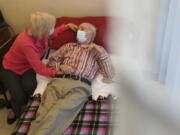 Patricia Sain visits with her husband Clyde Sain, who is in long term care, at Bergen New Bridge Medical Center in Paramus, N.J., Thursday, April 8, 2021. This was the first visit since early March 2020 that Patricia has been able to touch her husband and visit with him indoors.