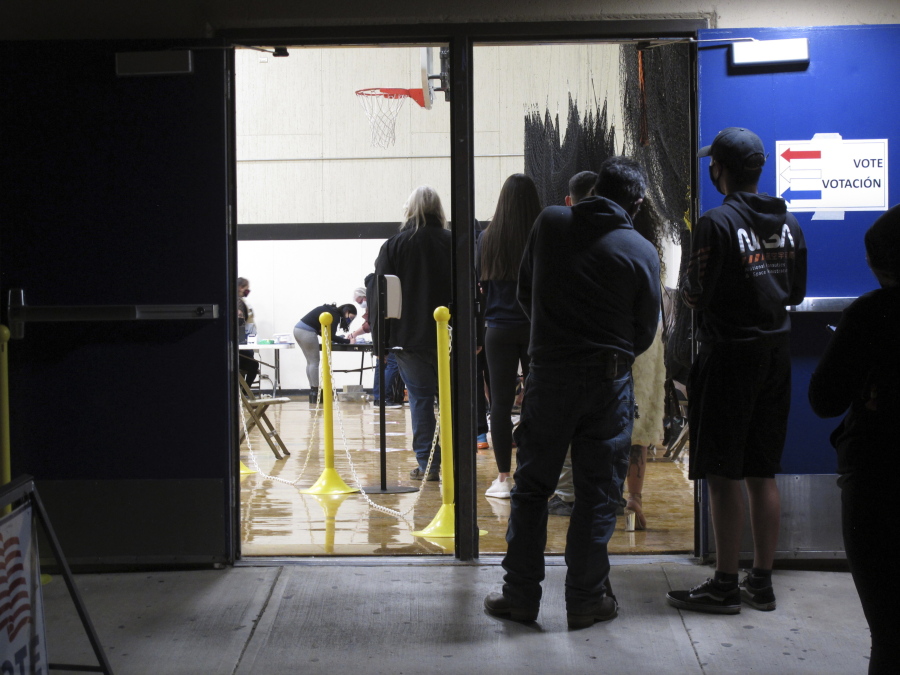 FILE - In this Nov. 3, 2020, file photo, some of the last voters wait in line to cast their ballots after the line was cut off at 7 p.m., local time, outside the gymnasium at Reed High School in Sparks, Nev. Everyone in line when the polls closed at 7 p.m. was allowed to vote in Washoe County, where registration is split evenly between the two major parties in the northern part of the state. A new survey measuring the popularity of major pieces of sweeping legislation in Congress finds solid support from Americans for Democrats&#039; proposals to overhaul voting in the U.S. The Associated Press-NORC Center for Public Affairs Research poll found about half of Americans support expanding access to early and mail voting, while about 3 in 10 opposed the ideas and the rest had no opinion.
