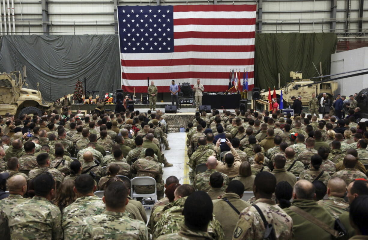 FILE- in this Sunday, Dec. 24, 2017, photo, Gen. Joseph Dunford, chairman of the Joint Chiefs of Staff speaks during a ceremony on Christmas Eve at a U.S. airfield in Bagram, north of Kabul, Afghanistan. The U.S. military has begun shipping equipment and winding down contracts with local service providers ahead of the May 1 start of the final phase of its military pullout from Afghanistan, a U.S. Defense Department official said Thursday, April 22, 2021.