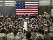 FILE- in this Sunday, Dec. 24, 2017, photo, Gen. Joseph Dunford, chairman of the Joint Chiefs of Staff speaks during a ceremony on Christmas Eve at a U.S. airfield in Bagram, north of Kabul, Afghanistan. The U.S. military has begun shipping equipment and winding down contracts with local service providers ahead of the May 1 start of the final phase of its military pullout from Afghanistan, a U.S. Defense Department official said Thursday, April 22, 2021.