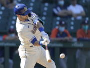 Seattle Mariners' Mitch Haniger hits an RBI-double during the seventh inning of a baseball game against the Houston Astros, Sunday, April 18, 2021, in Seattle. (AP Photo/Ted S.