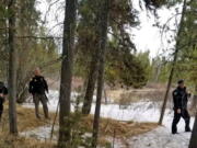 In this photo provided by the Gallatin County Sheriff's Office, officers from the sheriff's office and West Yellowstone Police Department are seen near the scene of a grizzly bear mauling just outside Yellowstone National Park near West Yellowstone, Mont. on April, 15, 2021. Authorities said Charles "Carl" Mock died Saturday of injuries sustained in the attack.