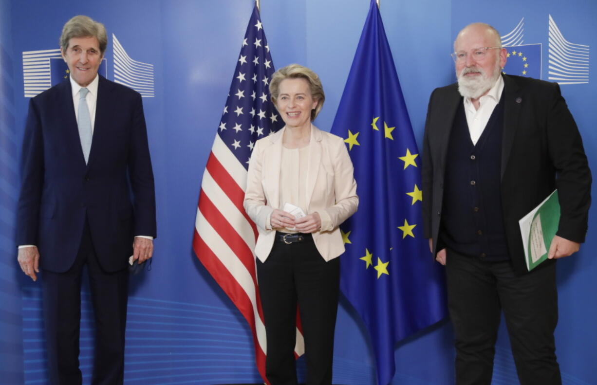 FILE - In this March 9, 2021 file photo, United States Special Presidential Envoy for Climate John Kerry, left, European Commission President Ursula von der Leyen, center, and European Commissioner for European Green Deal Frans Timmermans pose for photographers prior to a meeting at EU headquarters in Brussels. The European Union reached a tentative climate deal on Wednesday, April 21, 2021 that should make the 27-nation bloc climate-neutral by 2050, with member states and parliament agreeing on the targets on the eve of a virtual summit that U.S. President Biden will host.