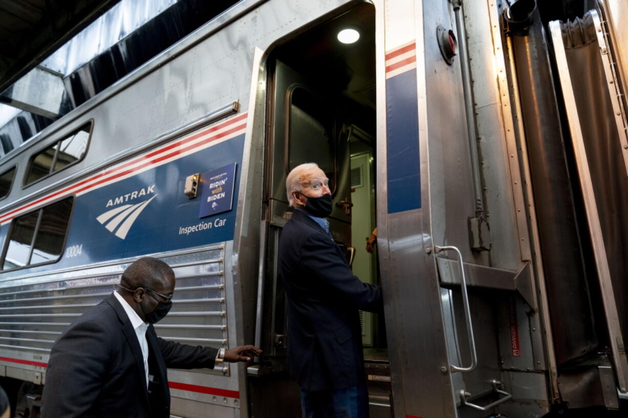 FILE - In this Sept. 30, 2020, file photo, then-Democratic presidential candidate former Vice President Joe Biden boards his train at Amtrak's Pittsburgh Train Station in Pittsburgh. President Joe Biden is set to help the nation's passenger rail system celebrate 50 years of service.