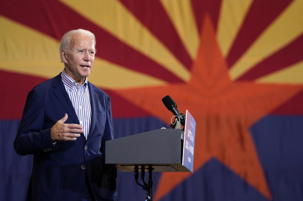 FILE - In this Oct. 8, 2020, file photo Democratic presidential candidate former Vice President Joe Biden speaks at the Carpenters Local Union 1912 in Phoenix. New census data that reassigned states' votes in Electoral College didn't upend Democrats' or Republicans' basic strategies for securing 270 votes needed to win the White House. But it hints at new paths not too far off. The 2020 census count will require a shift in congressional representation away from Rust Belt of the upper Midwest toward the southern Sun Belt.