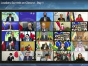 In this image from video world leaders participate in the White House Climate Leaders Summit via Zoom Thursday, April 22, 2021. The U.S. opened Thursday's summit, which is being held virtually by livestream because of the pandemic, with an ambitious pledge to cut by at least one-half the climate-wrecking coal and petroleum fumes that America is pumping out.