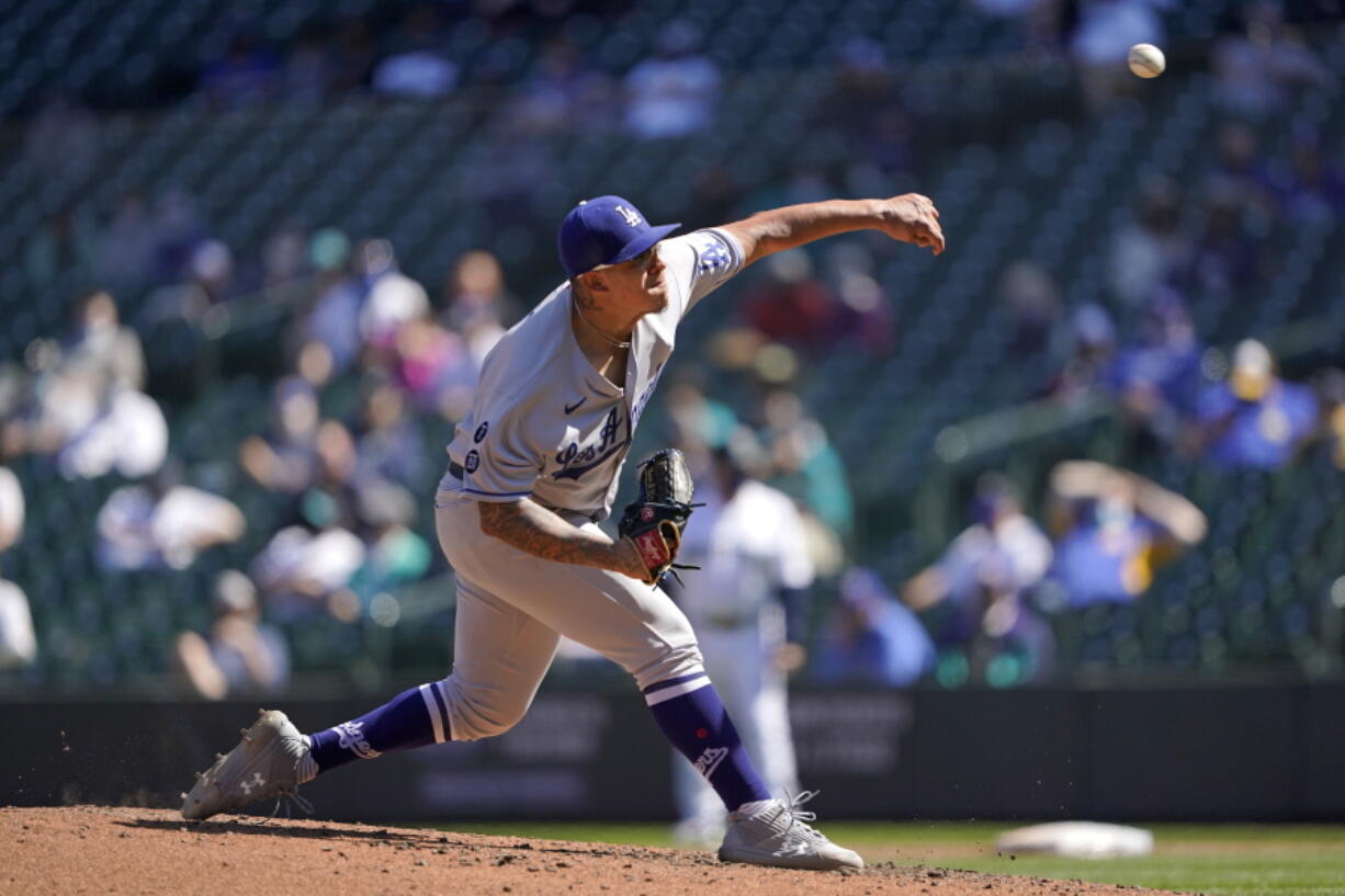 Los Angeles Dodgers starting pitcher Julio Urias throws against the Seattle Mariners in the fourth inning of a baseball game Tuesday, April 20, 2021, in Seattle. (AP Photo/Ted S.