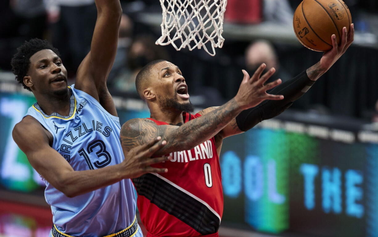 Portland Trail Blazers guard Damian Lillard (0) shoots over Memphis Grizzlies forward Jaren Jackson Jr. (13) during the first half of an NBA basketball game in Portland, Ore., Friday, April 23, 2021.