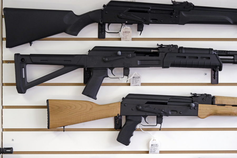 Semi-automatic rifles are displayed on a wall at a gun shop in Lynnwood.