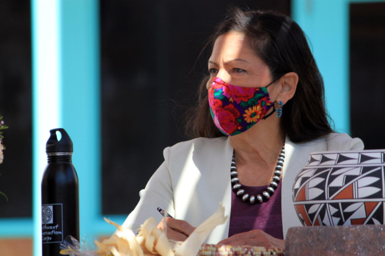 FILE - In this April 6, 2021, file photo, U.S. Interior Secretary Deb Haaland listens to tribal leaders and jots down notes during a round-table discussion at the Indian Pueblo Cultural Center in Albuquerque, N.M. Secretary Haaland will visit Utah this week before submitting a review on national monuments in the state. She's expected to submit a report to President Joe Biden after she meets with tribes and elected leaders at Bears Ears National Monument on Thursday, April 8, 2021.