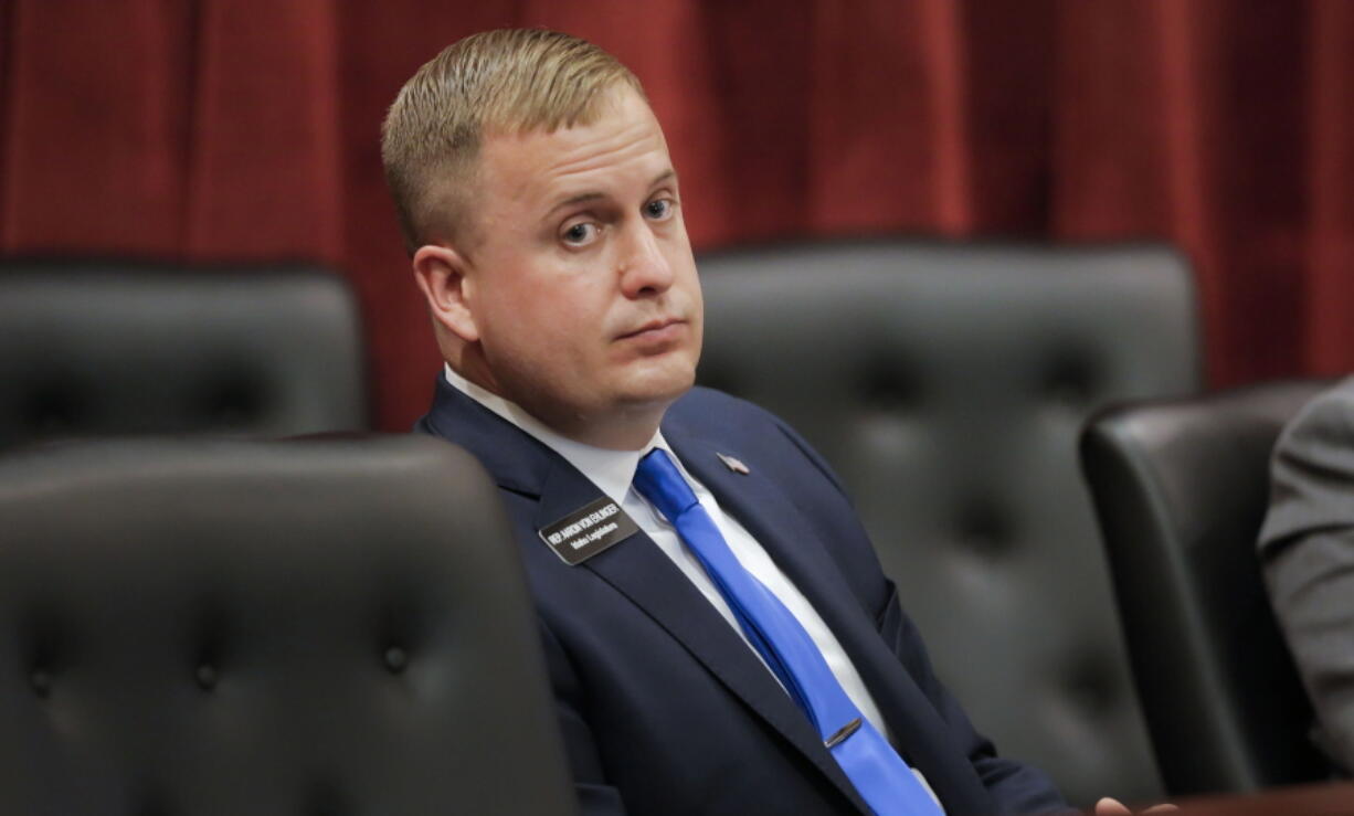 FILE - In this April 29, 2021 file photo, the Idaho Ethics and House Policy Committee votes during a hearing regarding state Rep. Aaron von Ehlinger, center back to camera  in Boise, Idaho. The committee agreed that von Ehlinger, accused of rape by a 19-year-old intern, should be formally censured and suspended from office.  As troubling as that case has been, it is just the latest in a long list of credible sexual misconduct accusations against state lawmakers since the #MeToo movement began more than three years ago.