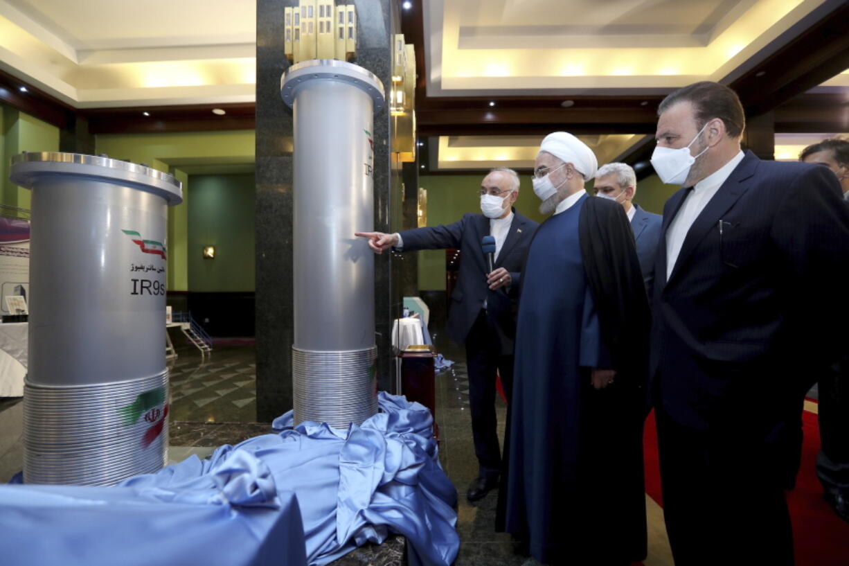 FILE - In this April 10, 2021, file photo released by the official website of the office of the Iranian presidency, Iranian President Hassan Rouhani, second from right, listens to the head of the Atomic Energy Organization of Iran Ali Akbar Salehi while visiting an exhibition of Iran&#039;s new nuclear achievements in Tehran, Iran. Iran&#039;s nuclear program has been targeted by diplomatic efforts and sabotage attacks over the last decade, with the latest incident striking its underground Natanz facility. The attack Sunday, April 11, 2021 at Natanz comes as world powers try to negotiate a return by Iran and the U.S. to Tehran&#039;s atomic accord.