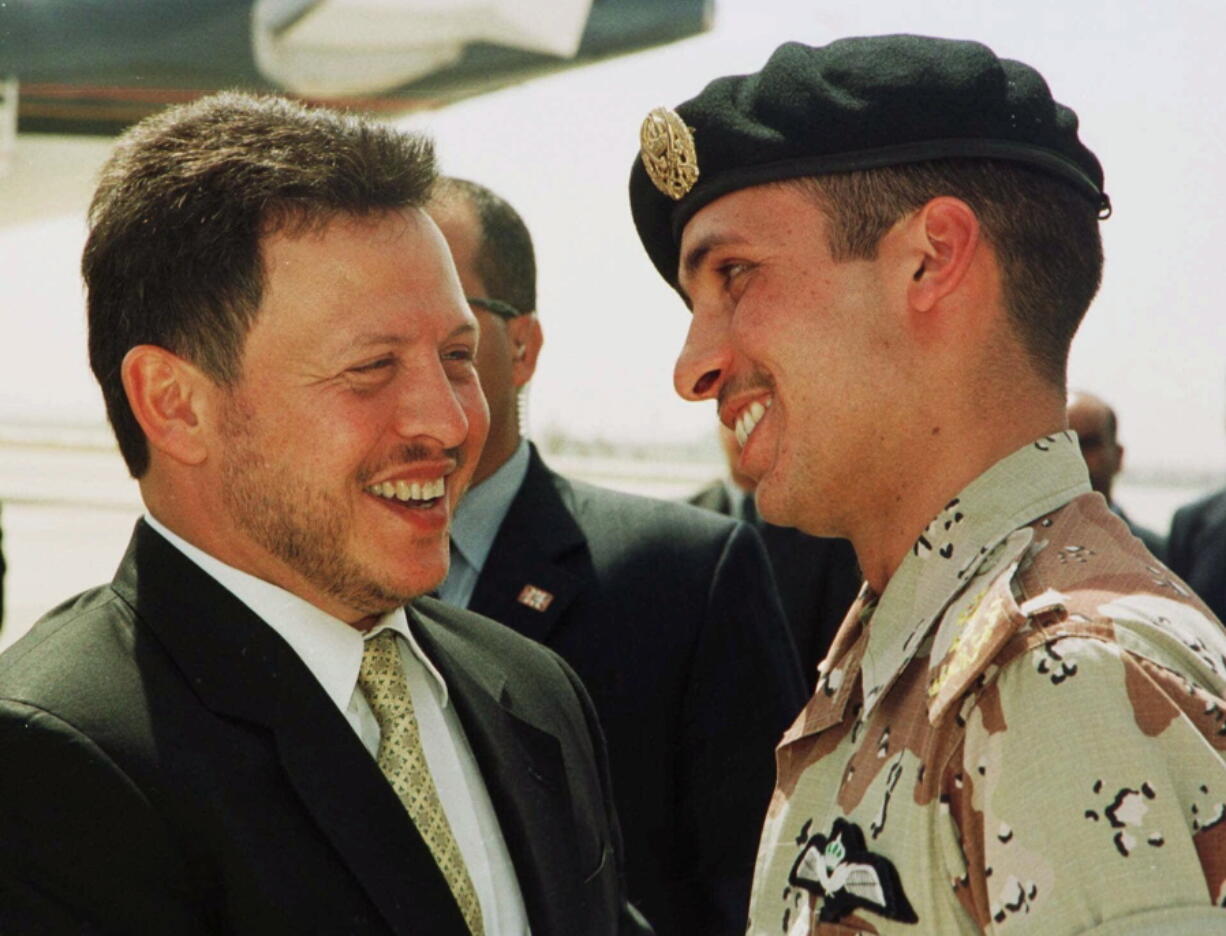 FILE - In this April 2, 2001, file photo, Jordan&#039;s King Abdullah II laughs with his half brother Prince Hamzah, right, shortly before the monarch embarked on a tour of the United States. Prince Hamzah said in a recording released Monday, April 5, that he will defy government threats ordering him to stay at home and refrain from public statements following accusations he was behind a plot to destabilize the kingdom.