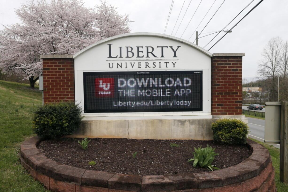 FILE - In this, Nov. 13 2019, file photo, Liberty University President Jerry Falwell Jr. talks to Donald Trump Jr. about his new book "Triggered" during convocation at Liberty University in Lynchburg, Va.  Liberty University has filed a civil lawsuit against its former leader, Jerry Falwell Jr., seeking millions in damages after the two parted ways acrimoniously last year. The Associated Press obtained the complaint, which was filed Thursday, April 15, 2021 in Lynchburg Circuit Court.