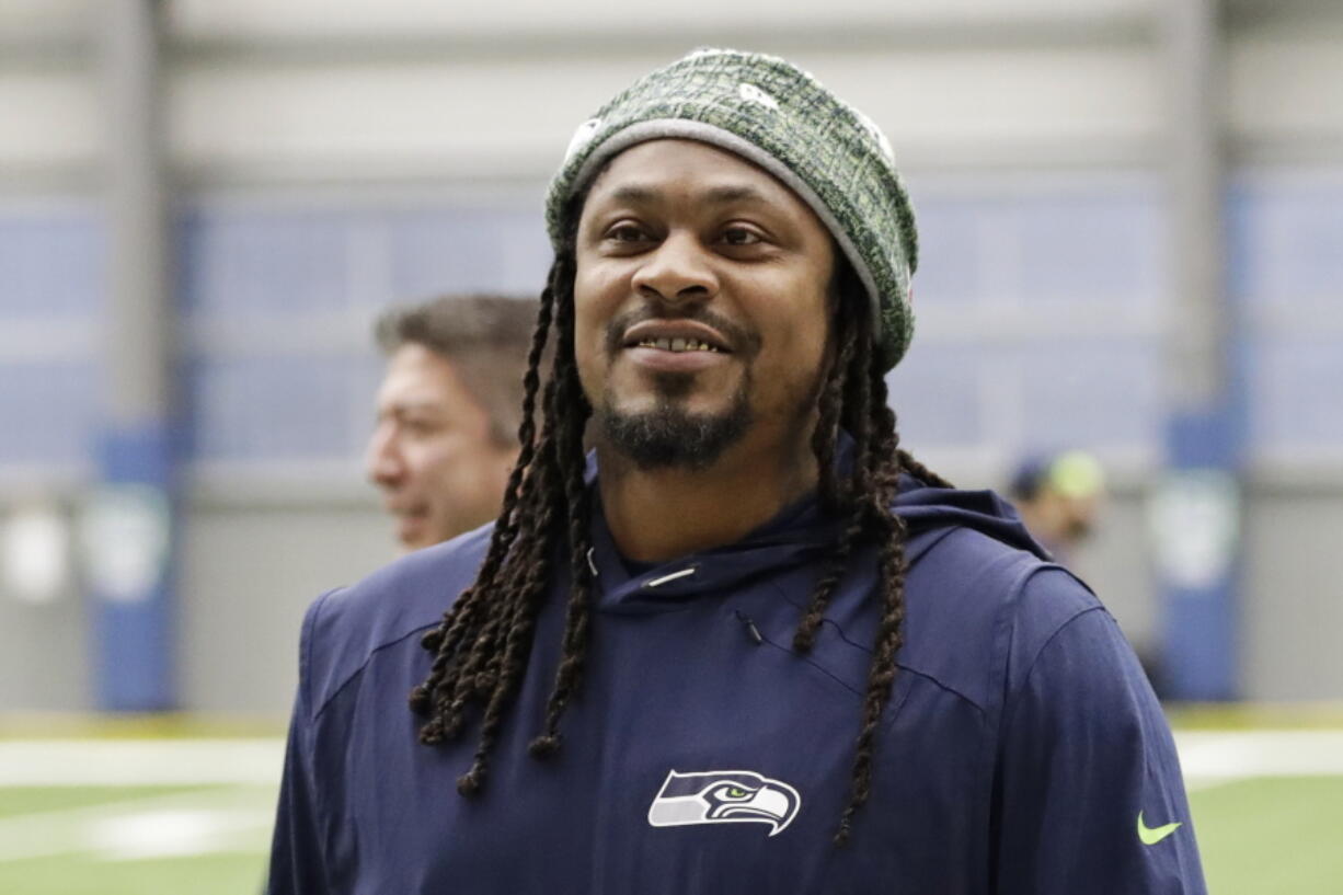 During Marshawn Lynch's 12 NFL seasons he earned a reputation for his fearless style on the field, while remaining one of the league's most reclusive figures off the field. Now the retired running back is lending his voice to try to help members of Black and Hispanic communities make more informed decisions about receiving COVID-19 vaccines.  (AP Photo/Ted S.