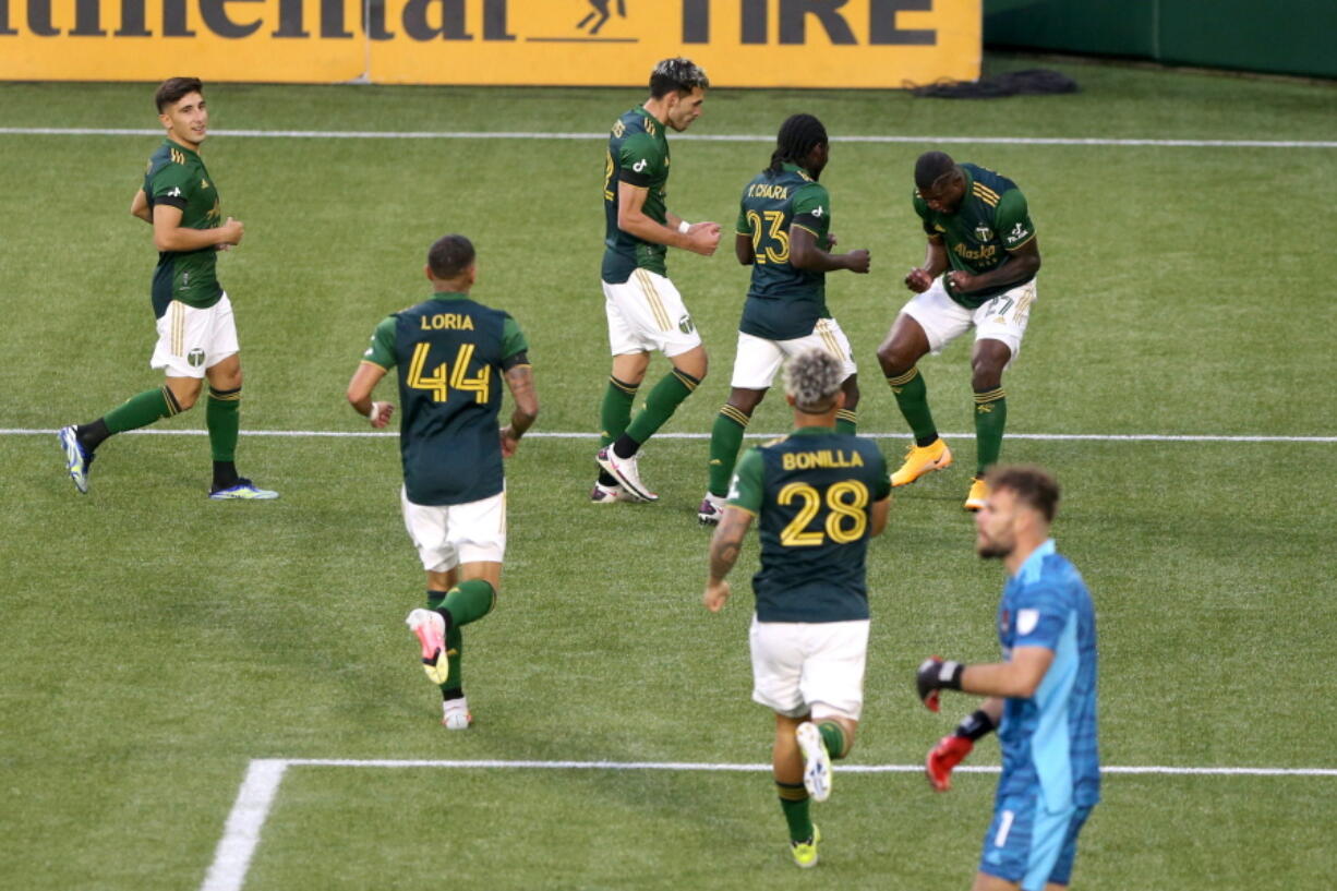 Portland Timbers celebrate a goal by Dairon Asprilla (27) during an MLS soccer match against the Houston Dynamo on Saturday, April 24, 2021, in Portland, Ore.