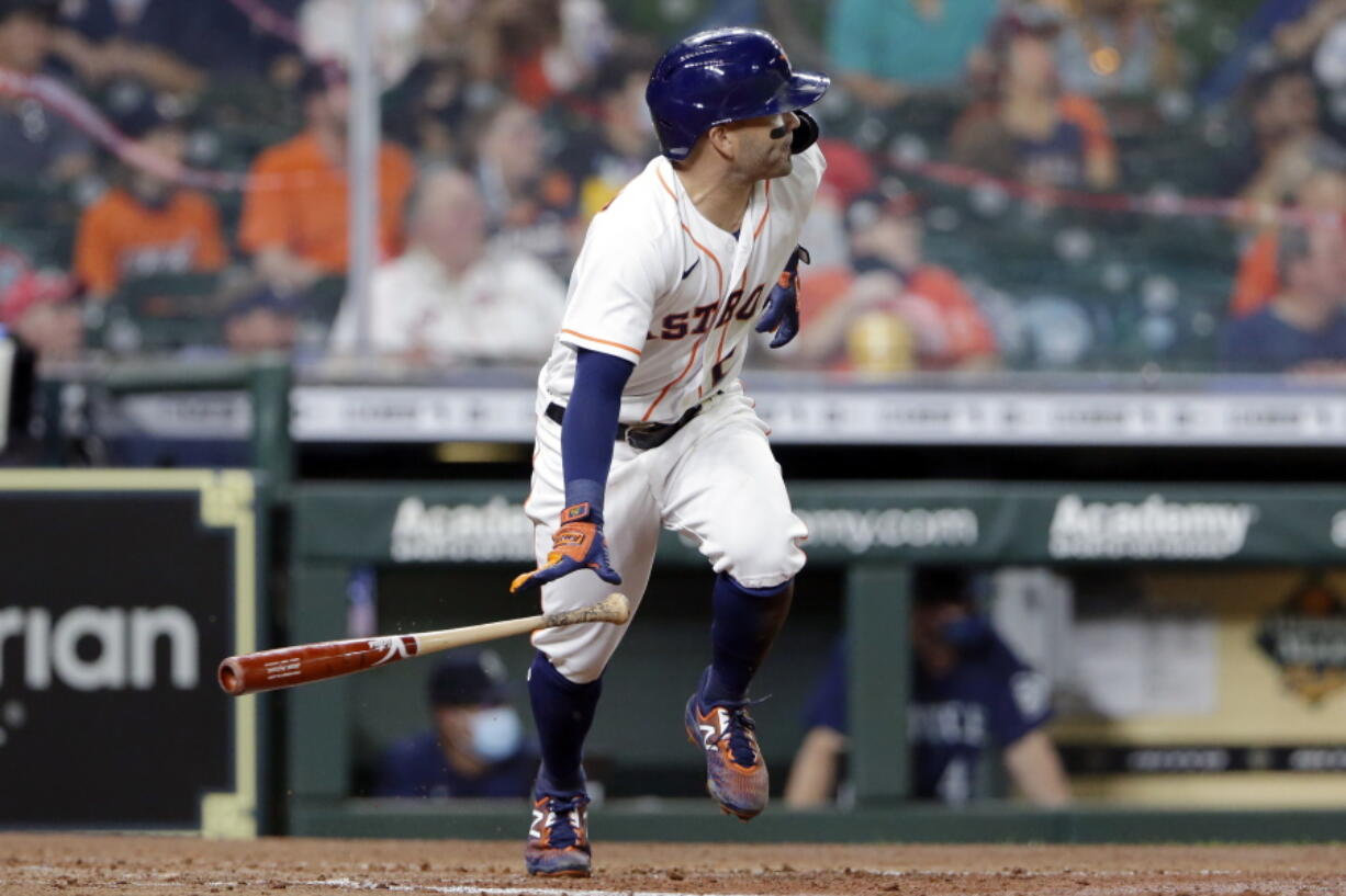 Houston Astros' Jose Altuve flips his bat as he watches his two-run RBI single against the Seattle Mariners during the fourth inning of a baseball game Monday, April 26, 2021, in Houston. This game is the return to play for Altuve after being diagnosed with COVID-19.