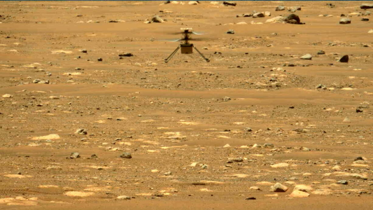 In this image made available by NASA, the Mars Ingenuity helicopter hovers above the surface of the planet during its second flight on Thursday, April 22, 2021.