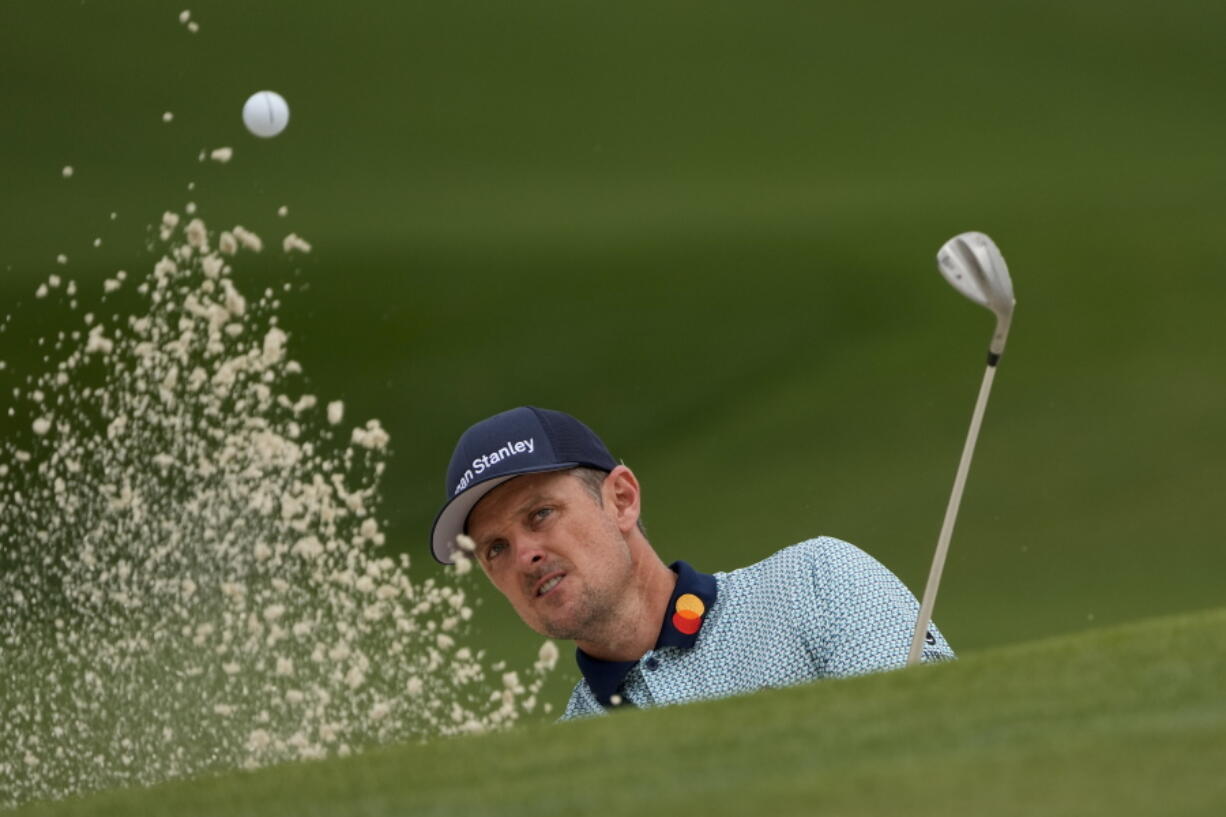 Justin Rose, of England, hits out of a bunker on the seventh hole during the second round of the Masters golf tournament on Friday, April 9, 2021, in Augusta, Ga.