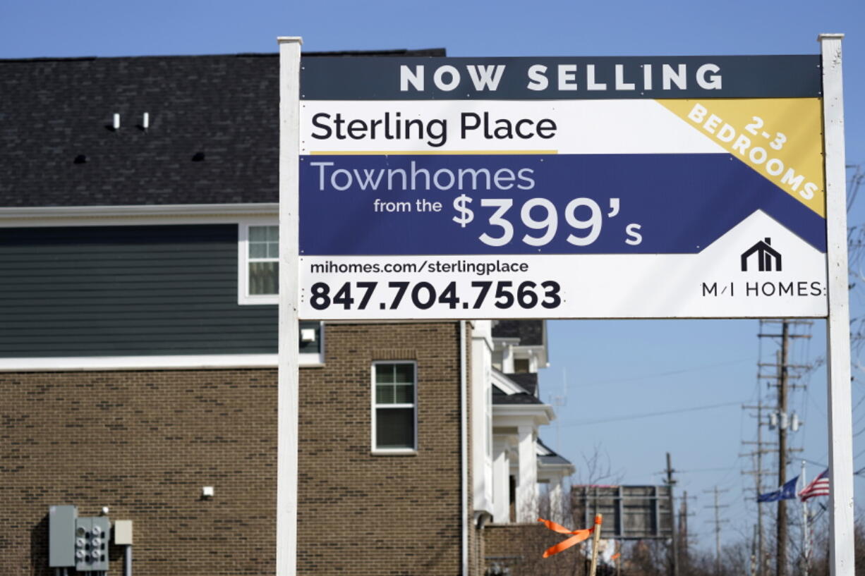 An advertising sign for building land stands in front of a new home construction site in Northbrook, Ill., Sunday, March 21, 2021.  Mortgage rates fell for a second straight week amid signs of economic improvement. Mortgage buyer Freddie Mac reports, Thursday, April 15,  that the benchmark 30-year home-loan rate declined to 3.04% this week from 3.13% last week.  (AP Photo/Nam Y.