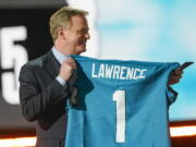 NFL Commissioner Roger Goodell holds a Jacksonville Jaguars jersey as he announces that the Jaguars had chosen Clemson quarterback Trevor Lawrence with the first pick in the NFL football draft, Thursday April 29, 2021, in Cleveland.